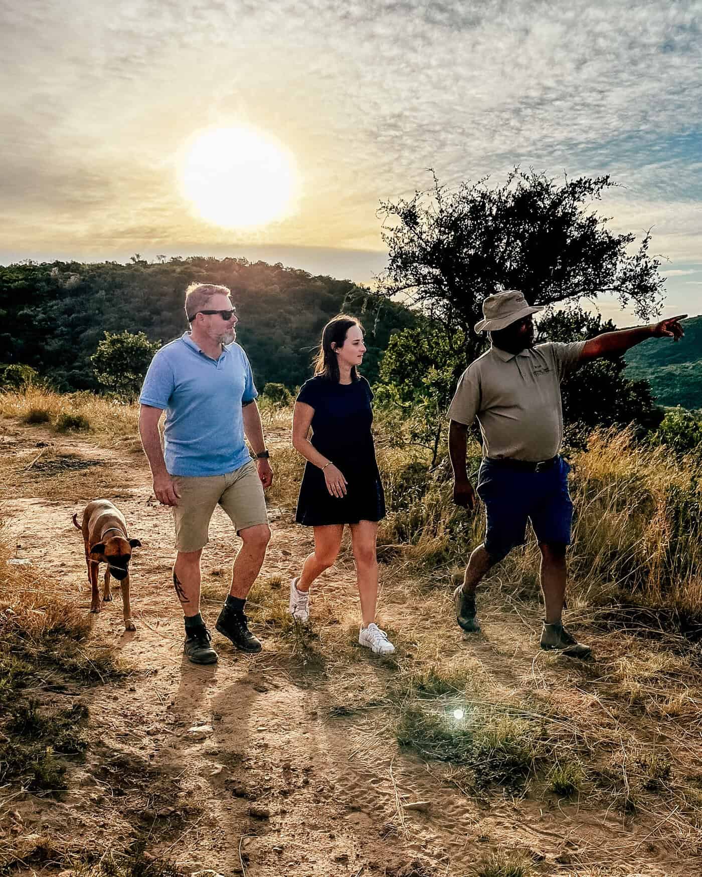 3 people walking through bushveld